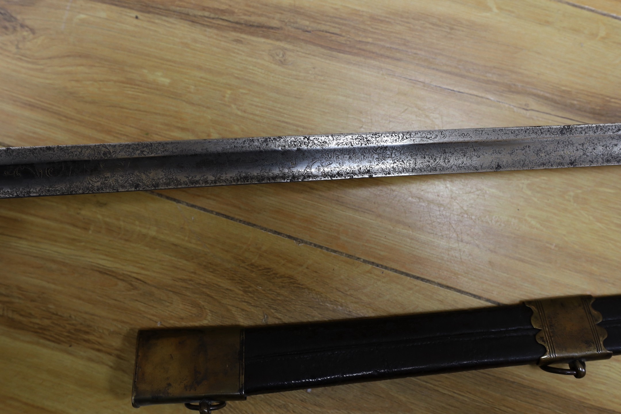 An 18th century European brass hilted sword and scabbard. 89cm long